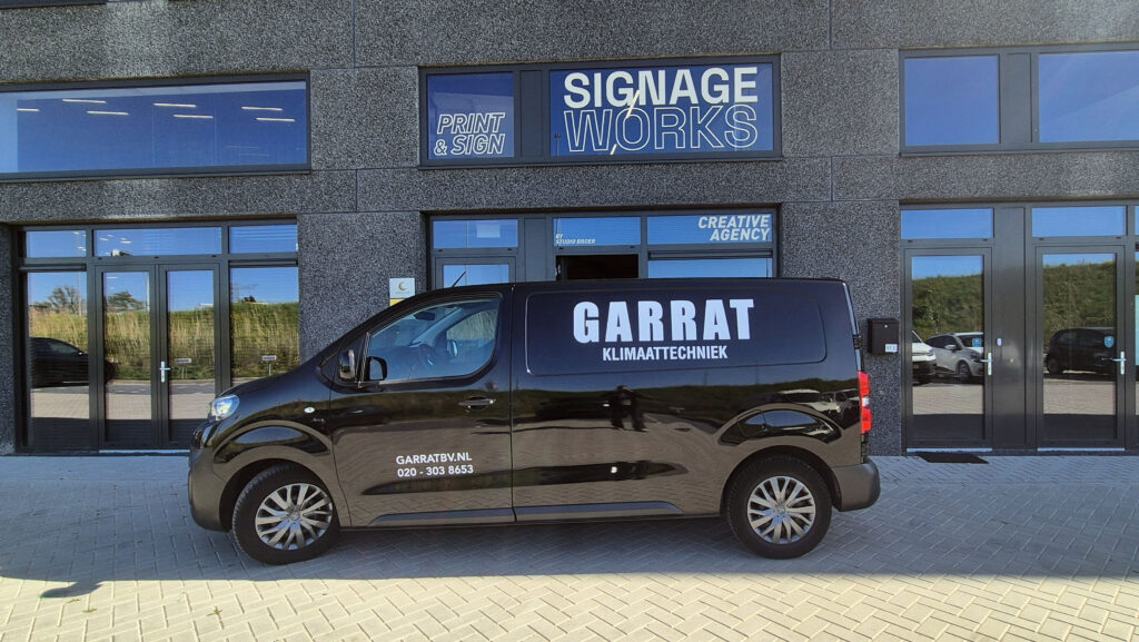 Bus met belettering voor het pand van SignageWorks